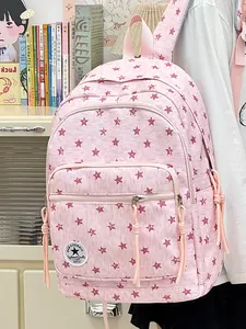 Close-up of pink student backpack featuring all-over star pattern and dual compartments