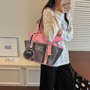 Detailed view of a pink and black mesh tote bag with a matching coin pouch
