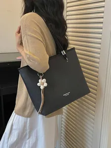 Elegant black large capacity textured tote bag for women featuring white flower charm