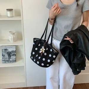 Fashionable black and white polka dot tote bag with elegant flower charm for women