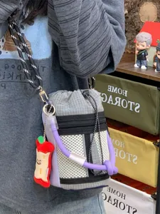Minimalist niche design crossbody bucket bag with purple rope detail and apple charm