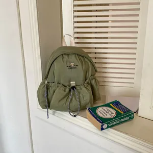 Vista detallada de una mochila acolchada verde salvia con diseño de nicho de moda