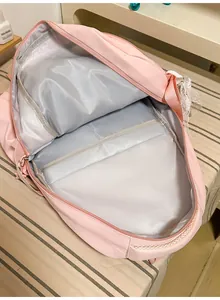 Detail view showing the large internal storage compartments of the pink school backpack.