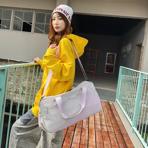 Asian model carrying a large lilac nylon duffel bag for trendy summer travel style