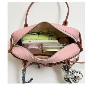 Detailed interior view of a pink Boston bag showing its large storage capacity for essentials