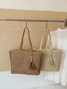 Sacs cabas minimalistes en paille tressée avec pompons en couleurs marron et beige