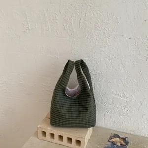 Detailansicht der grünen karierten Beuteltasche mit süßem rotem Herzmuster-Futter