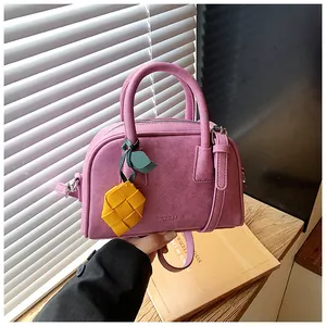 Stylish purple pillow handbag for women featuring a creative yellow woven pineapple charm
