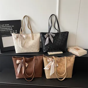 Four colors of stylish geometric embossed tote bags with elegant decorative ribbon bows