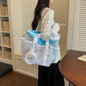 White mesh tote bag with blue lining and round pouch shown in a lifestyle setting
