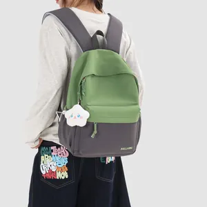 Stylish green and grey color-blocked school backpack for women shown on a model outdoors