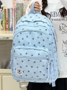 Light blue school backpack with star pattern and large front pocket detail view
