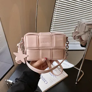 Pink woven leather small square bag featuring star charm and chunky metal chain strap