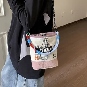 Detailaufnahme einer Nischen-Eimertasche aus Segeltuch mit buntem geflochtenem Seilgriff.