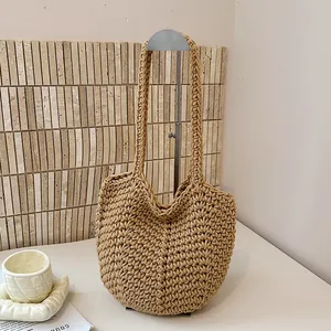 Macro view showing the intricate handmade crochet texture of the beige tote bag.