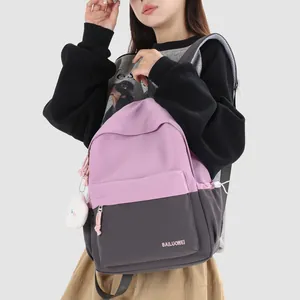 Lightweight pink and grey color-block school backpack with cute plush pendant detail