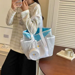Close-up of white mesh tote bag with blue inner pouch and fashionable model styling