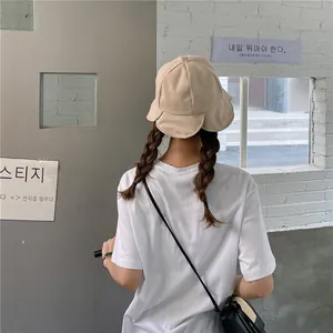 Detailed back view of a women's beige ruffled bucket hat with unique wavy brim for sun protection