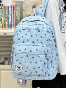 Close-up of light blue backpack with star patterns on a student for school and travel