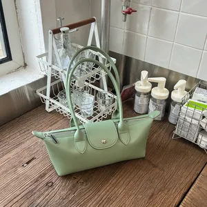 Sac dumpling en cuir vert sauge avec longues bandoulières pour le trajet quotidien