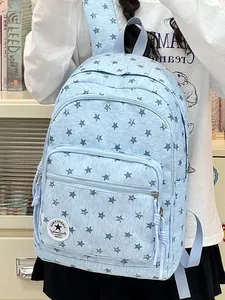 Light blue school backpack with star pattern worn by a student in a casual setting.