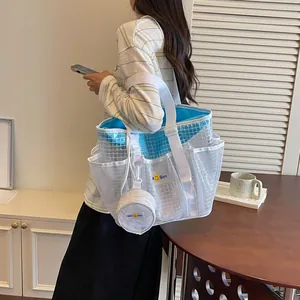 Detail view of white mesh tote bag featuring blue inner pouch and matching coin purse.