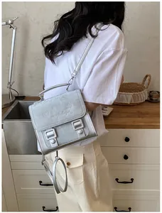 Silver sweet collegiate style backpack with heart print shown being worn by a model