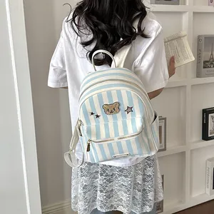 Trendy blue and white striped mini backpack featuring a cute bear patch for girls