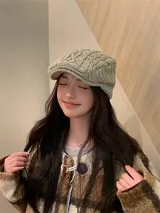 Asian woman wearing a vintage khaki knitted newsboy cap for winter warmth