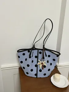 Stylish light blue tote bag with black polka dots and palm tree charm decoration