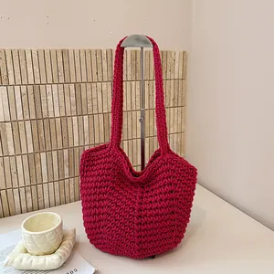 Detailed view showing the intricate texture of this vibrant magenta hand-woven crochet tote bag.