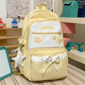 Close-up of a cute yellow Korean style schoolbag with star patches and a ribbon bow detail