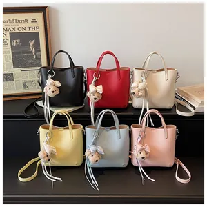 Collection of women's lychee pattern bucket bags in six colors with bear charms.