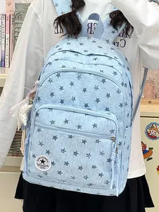Light blue backpack with dark blue star pattern worn by a model in a school setting
