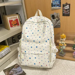 Detailed view of white student backpack featuring colorful star patterns in a cozy setting