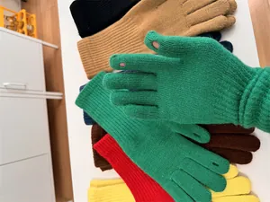 Close-up detail of colorful knitted winter gloves with finger holes for easy touchscreen use