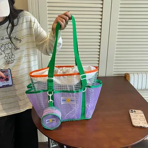 Detailed view of women's large mesh tote bag with purple panels and green handles