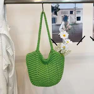 Artisan green crochet shoulder bag with intricate woven texture and daisy detail