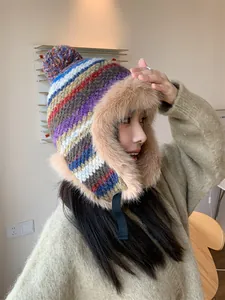 Detailed side view of a colorful striped winter trapper hat with soft faux fur ear flaps