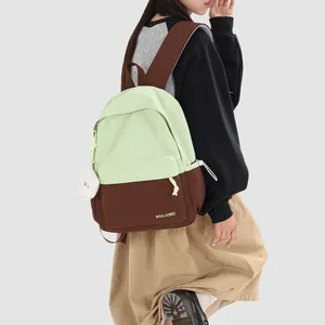 Side view of a female model wearing a mint green and brown two-tone campus backpack