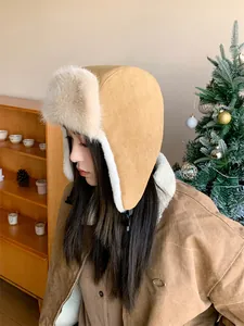 Side view detail of a khaki corduroy aviator hat with soft white faux fur lining
