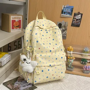 Detailed view of a yellow Japanese style backpack with cute star patterns and plush charm