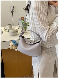 Premium light purple pebbled leather hobo bucket bag with a cute bear charm accessory