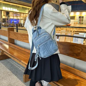 Stylish rear view of a female model wearing a large capacity light blue denim backpack