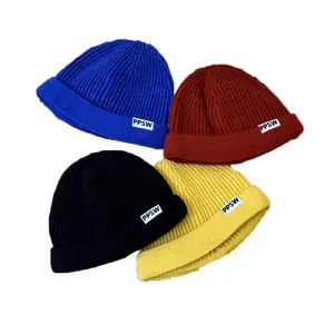 Four colors of children's ribbed knitted beanie hats with PPSW label on white background