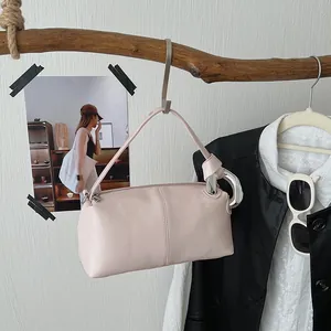 Close-up of a pink retro pillow handbag with niche knotted design details
