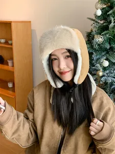 Close-up shot of a cozy winter bomber hat with ear flaps worn by a female model in a lifestyle setting