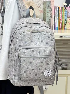 Large capacity grey school backpack with star pattern for teenage girls in a cozy room
