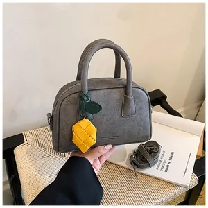 High-end gray pillow bag for women with yellow woven charm and shoulder strap