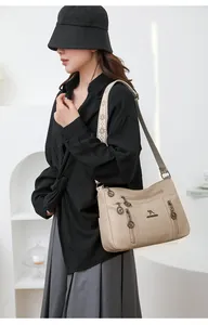 Stylish beige large-capacity crossbody bag for women with multi-zipper detail